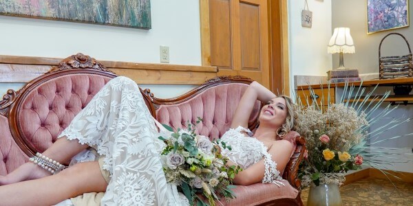 A bride relaxing on a couch in a bridal suite